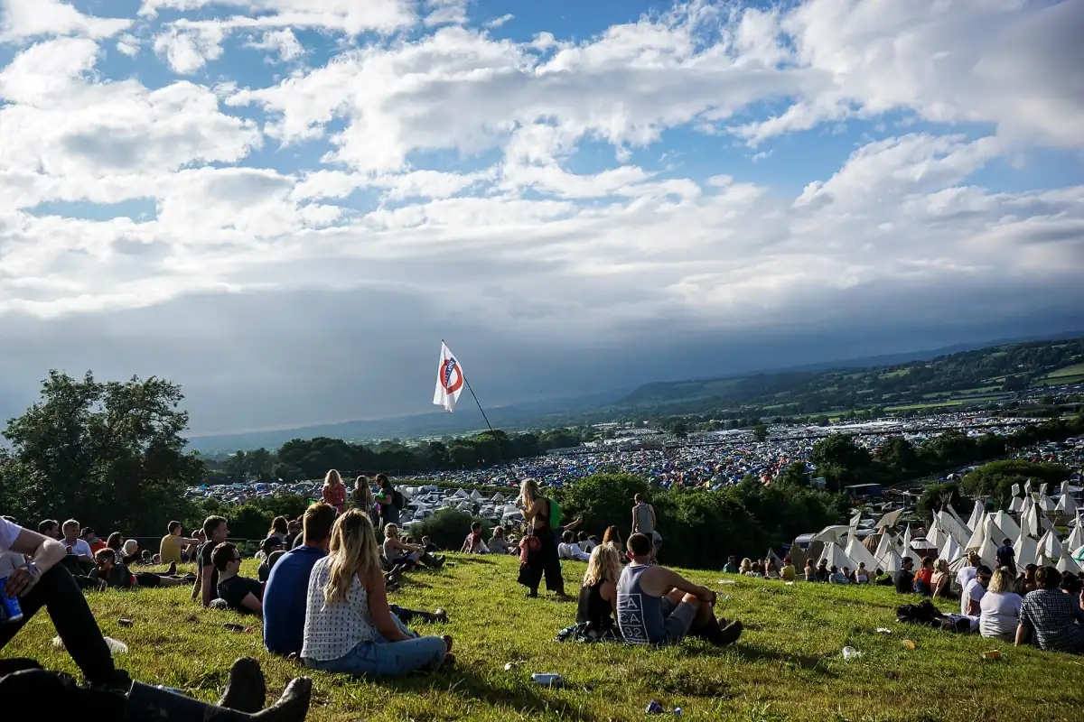 Festival-goers on the hill above the site